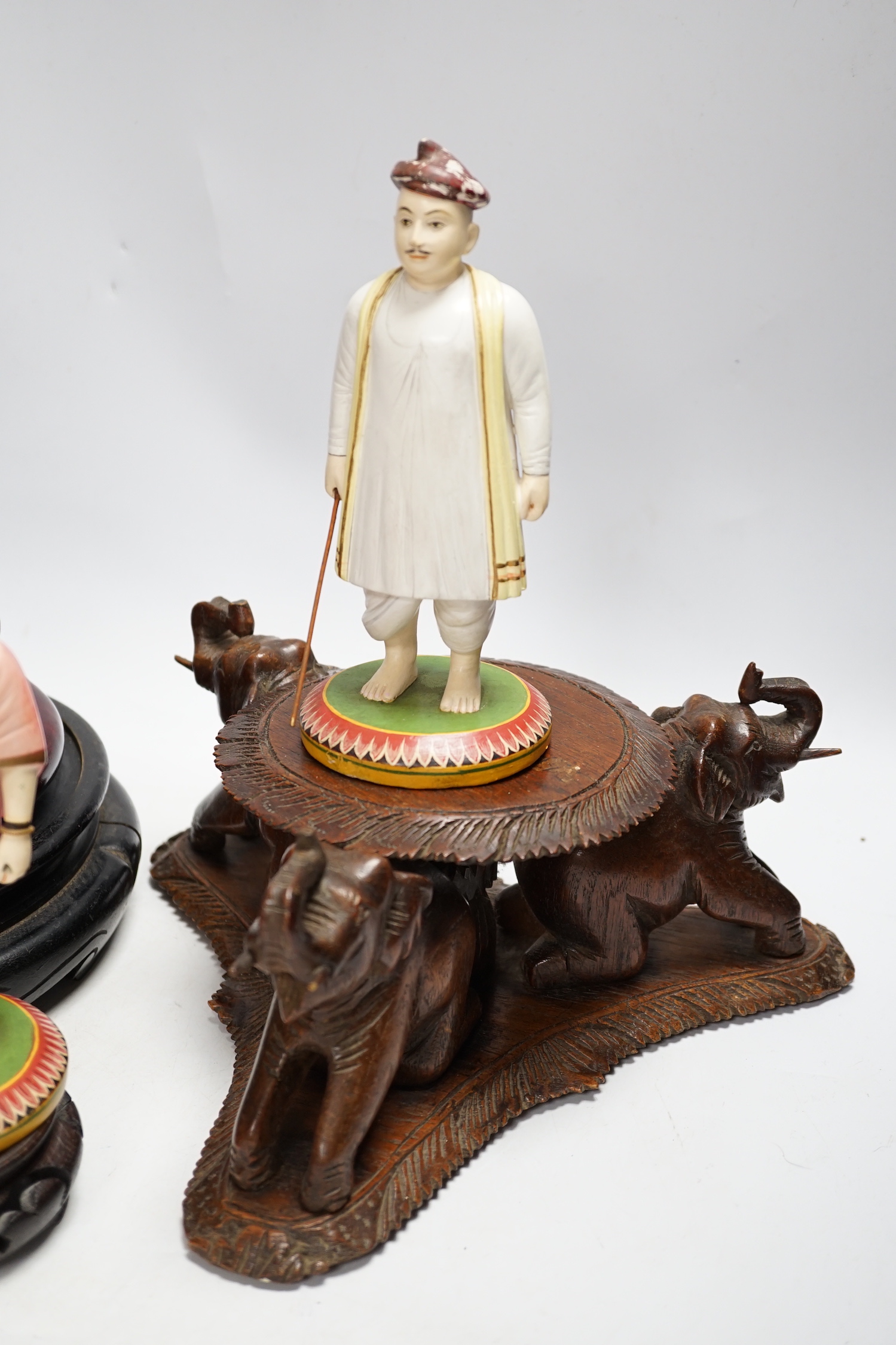 Two Indian carved and painted wood figures, an Indian or Burmese carved wood stand another various wood stands, largest 24cm in diameter
